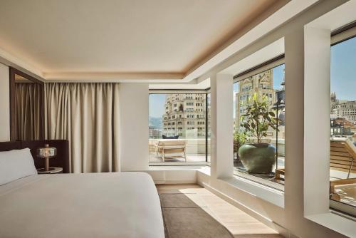a bedroom with a bed and a large window at Nobu Hotel Madrid in Madrid
