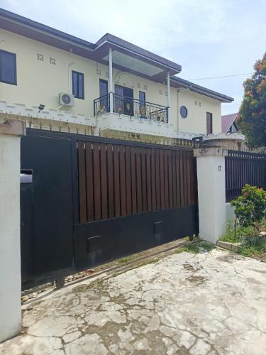 a black gate in front of a house at Kos Pramuka in Sunggal
