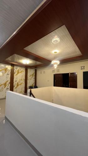 an office with a white desk and a ceiling at Kos Pramuka in Sunggal