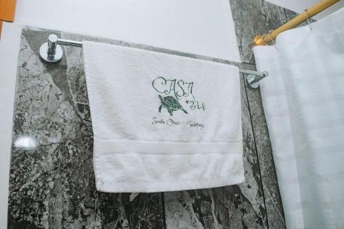 a towel hanging on a towel rack in a bathroom at #5 Mini Suite, Cerca de Todo, 2-3 people - AC in Puerto Ayora