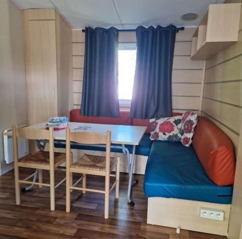 a small room with a table and a couch at Schatzele in Boofzheim