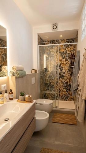 a bathroom with a toilet and a sink and a shower at B&B Mavi in Como
