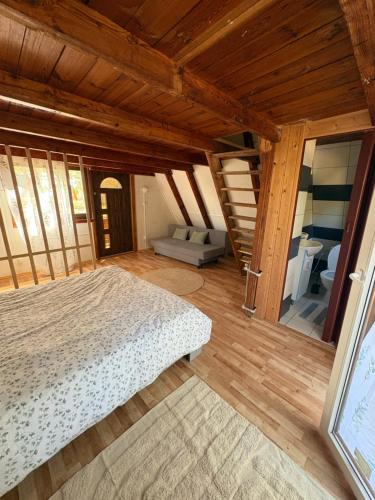 a large bedroom with a bed and a staircase at Przystań Kownatki in Kozłowo