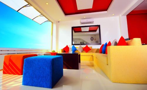 a living room with a yellow couch and colorful pillows at City Stay in Galle