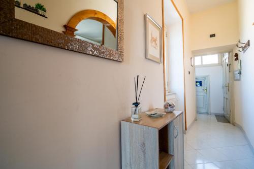 a hallway with a table and a mirror on the wall at Nido d'amore in Anagni