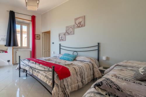 a bedroom with two beds and a window at Nido d'amore in Anagni
