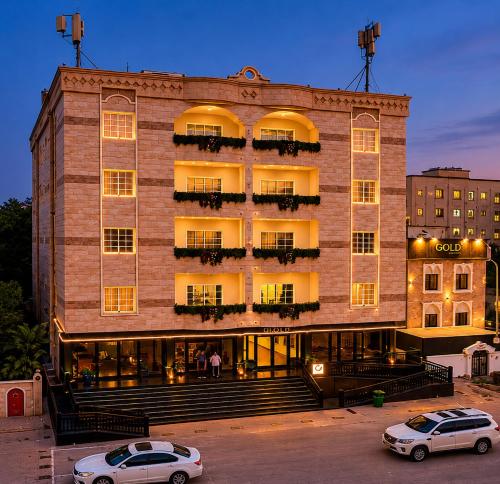 two cars parked in front of a building at AL KALDi in Salalah