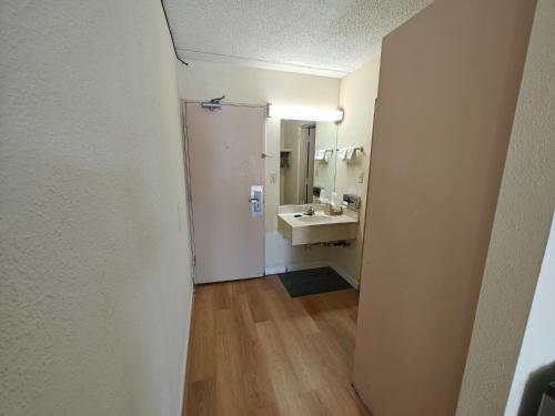 an empty bathroom with a sink and a mirror at Richmond - Quality Quarters Inn in Richmond