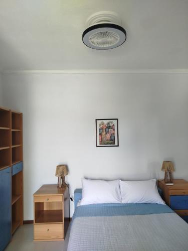 a bedroom with a bed and a nightstand and a lamp at Apostolis Seaside Living in Olympiada