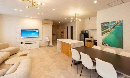 a kitchen and living room with a table and chairs at Priyado Kochi in Kochi