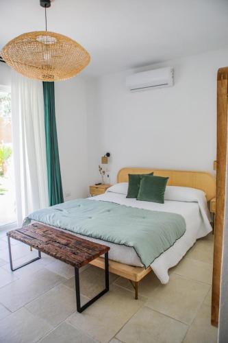 a bedroom with a bed and a table and a chandelier at BeB Villa Pacifica in Peschici