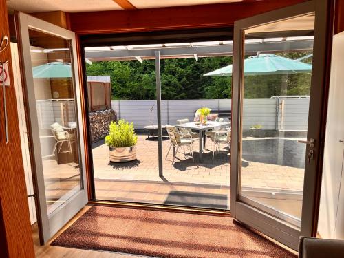a sliding glass door leading to a patio with a table at Tiny Haus Dornbirn in Dornbirn
