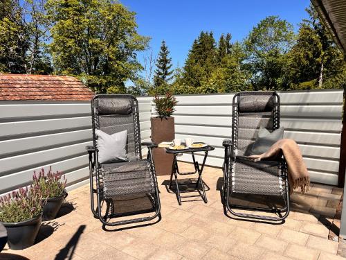 two chairs and a table on a patio at Tiny Haus Dornbirn in Dornbirn