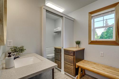 a bathroom with a sink and a toilet and a window at Pet-Friendly Quaint Cottage: Park-Like Setting in Monroe