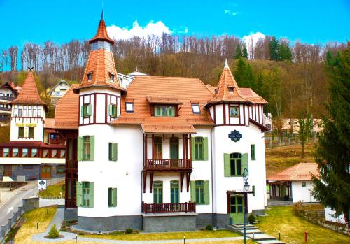 a large white house with an orange roof at Turul Villa in Sovata