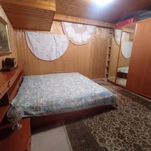a small bedroom with a bed and a window at Ferienwohnung im Krokusweg in Langenneufnach