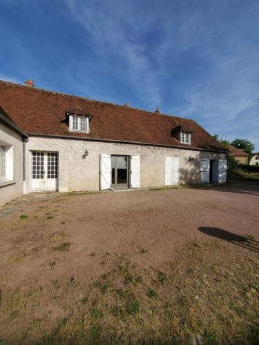 an old house with a large yard in front of it at Logement authentique et facile d'accès in Sermoise