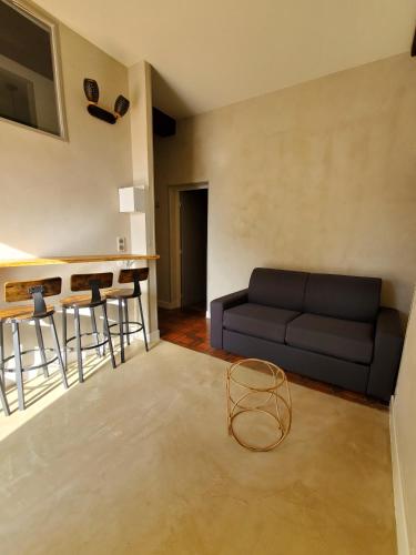 a living room with a couch and a table at Logement authentique et facile d'accès in Sermoise