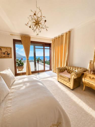 a bedroom with a bed and a couch and a window at Vila Angel in Bečići