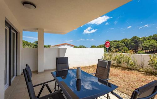 a patio with a table and chairs and a stop sign at Apartments at Villa Frida in Premantura
