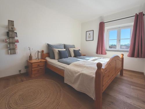 a bedroom with a bed and a window and a rug at Stefflhof in Gabersdorf