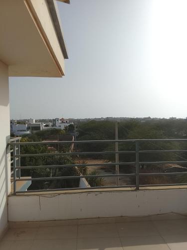 a balcony with a view of a field at Les chambres de la mangrove in Somone