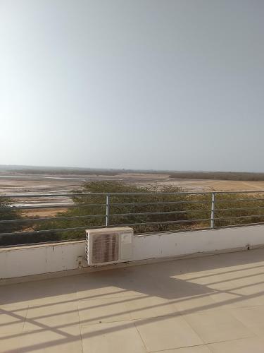 a microwave sitting on the ledge of a building at Les chambres de la mangrove in Somone