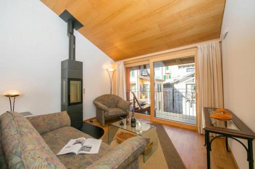 a living room with a couch and a fireplace at Ca' Melin with Balcony & Fireplace - Happy Rentals in Mugena