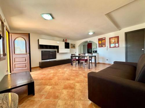 a living room with a couch and a table at Orange House in Bari Sardo