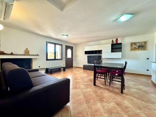 a living room with a couch and a table at Orange House in Bari Sardo