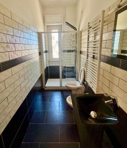 a bathroom with a sink and a toilet in it at BradAmare Seafront in Montesilvano