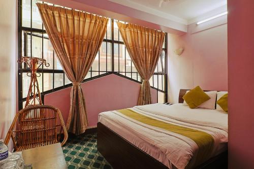 a bedroom with a bed and a large window at Hotel Lekali Homes in Kathmandu