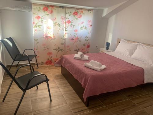 a bedroom with a bed with two towels on it at City Suites Budva in Budva