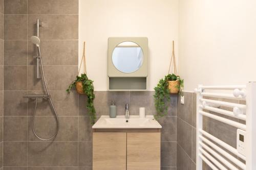 a bathroom with a sink and a shower at Villa Anita in Chevreuse