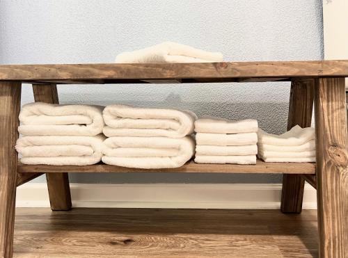 a shelf filled with towels on a wooden bench at The Mark at Surfside #8 in Surfside Beach