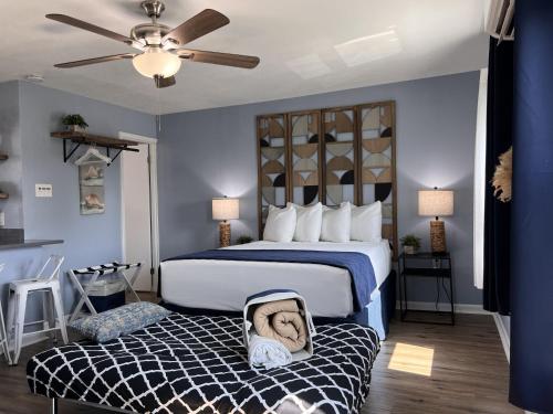 a bedroom with a bed with a baby in a suitcase at The Mark at Surfside #8 in Surfside Beach