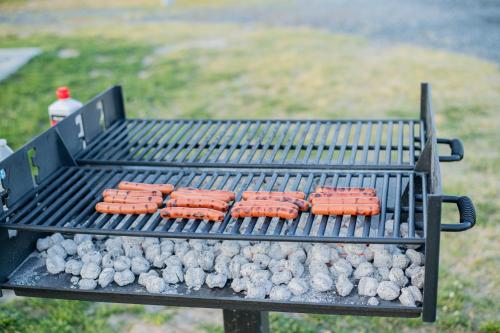 a bunch of hot dogs on a grill at Chincoteague Bay RV Resort & Cottages in Chincoteague