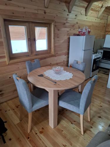 a dining room with a wooden table and chairs at Vila Gorska in Šavnik