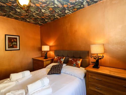a bedroom with two beds and a painting on the ceiling at Bib Knowl Farm in Littleborough