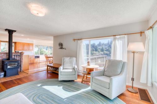 a living room with two chairs and a fireplace at Bamboo House - Meredith Lodging in Nehalem