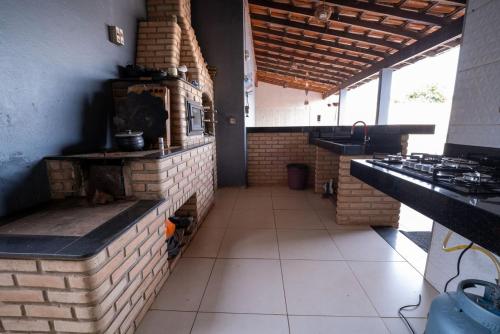 a kitchen with a brick oven in a room at Casa com Piscina Aquecida e Churras em Uberlândia in Uberlândia