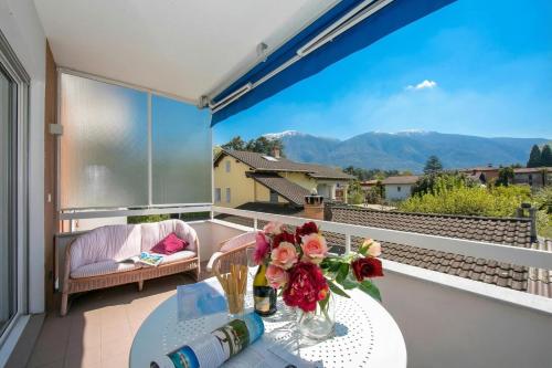a balcony with a table with flowers on it at Charm Apartment with Balcony and Parking - Happy Rentals in Ascona