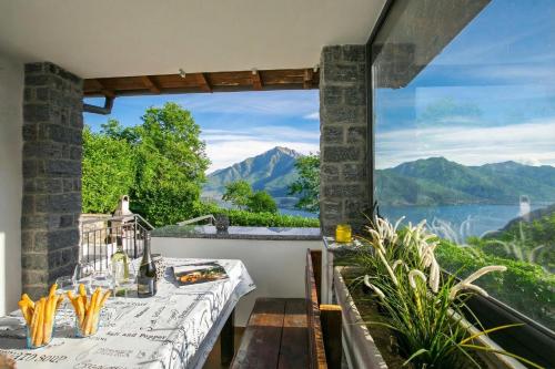 a balcony with a view of the water and mountains at Casa dei Galli in Gravedona