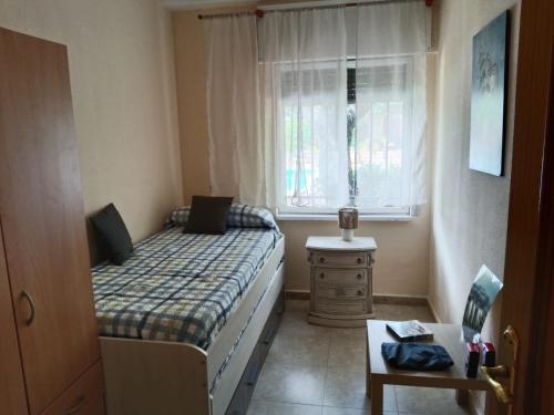 a small bedroom with a bed and a window at montepino 2 in Maello