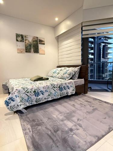a bedroom with two beds and a rug at Go Q Tambuli Seaside Studio in Maribago