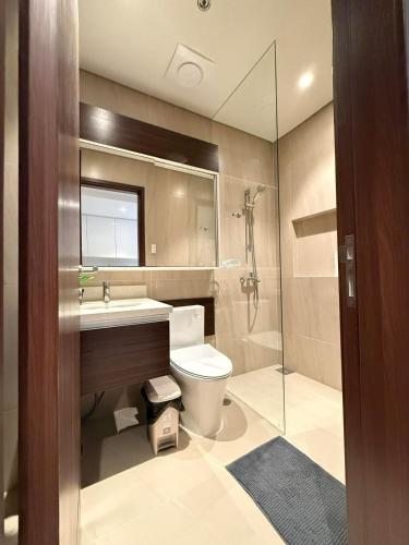 a bathroom with a toilet and a sink and a shower at Go Q Tambuli Seaside Studio in Maribago