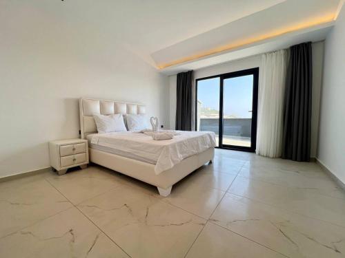 a bedroom with a large bed and a large window at Salam Residence 2 - Ladies-Only Pool & Family Pools in Alanya