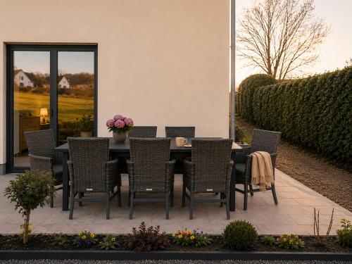 a dining table and chairs on a patio at Moderne Ferienwohnung,im fränkischen Seenland , 25 min Messe Nbg in Roth