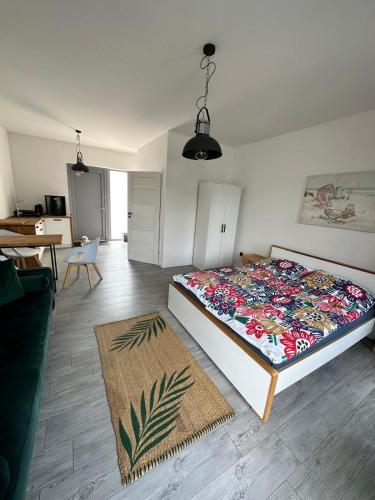 a bedroom with a bed with a colorful bedspread at Przystań Dębki in Dębki