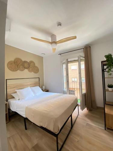 a bedroom with a bed with a ceiling fan at Grampy Boutique Hostal - Zaragoza Centro in Zaragoza